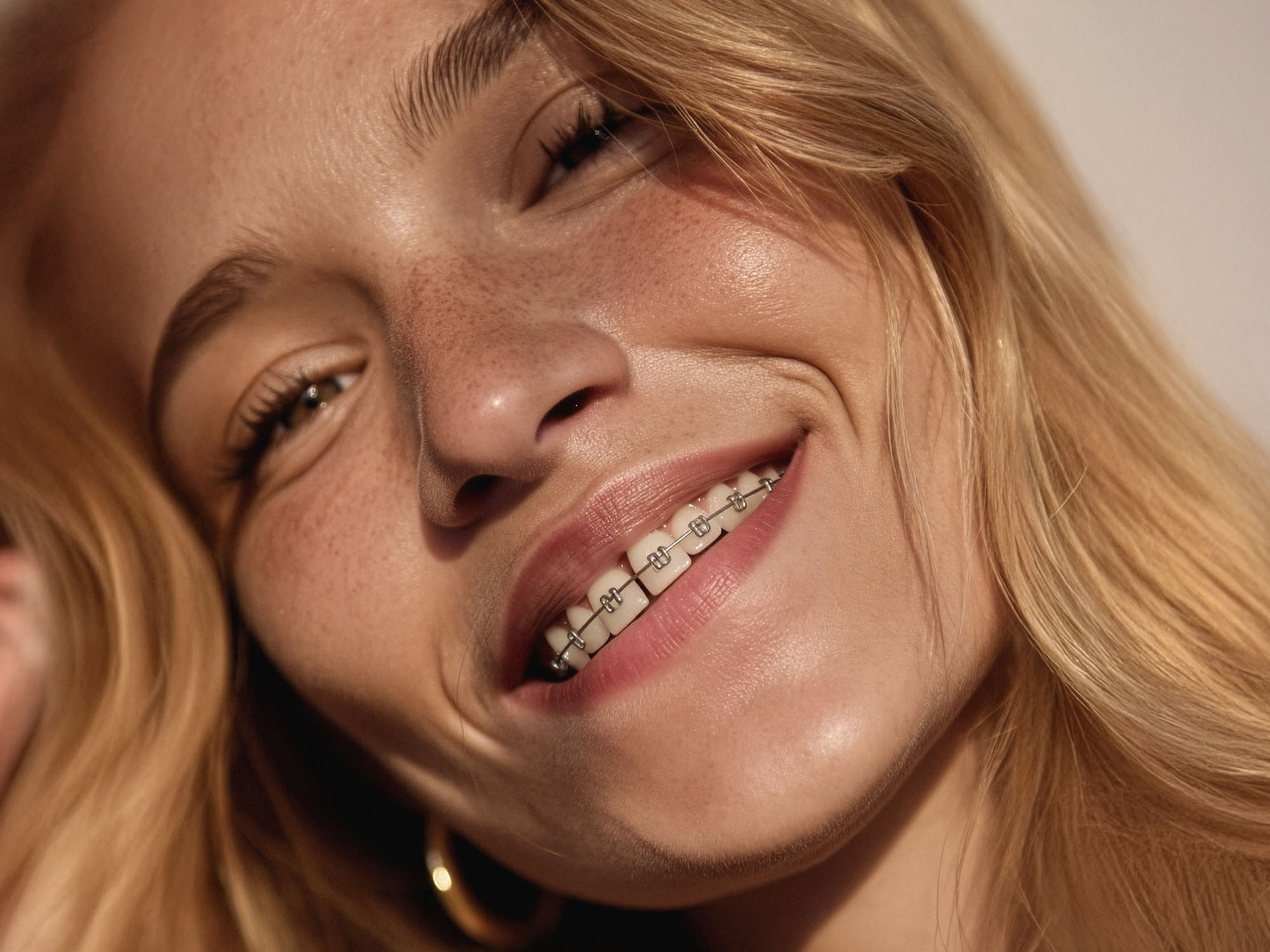 Lächelnde Frau mit Zahnspange im Sonnenlicht