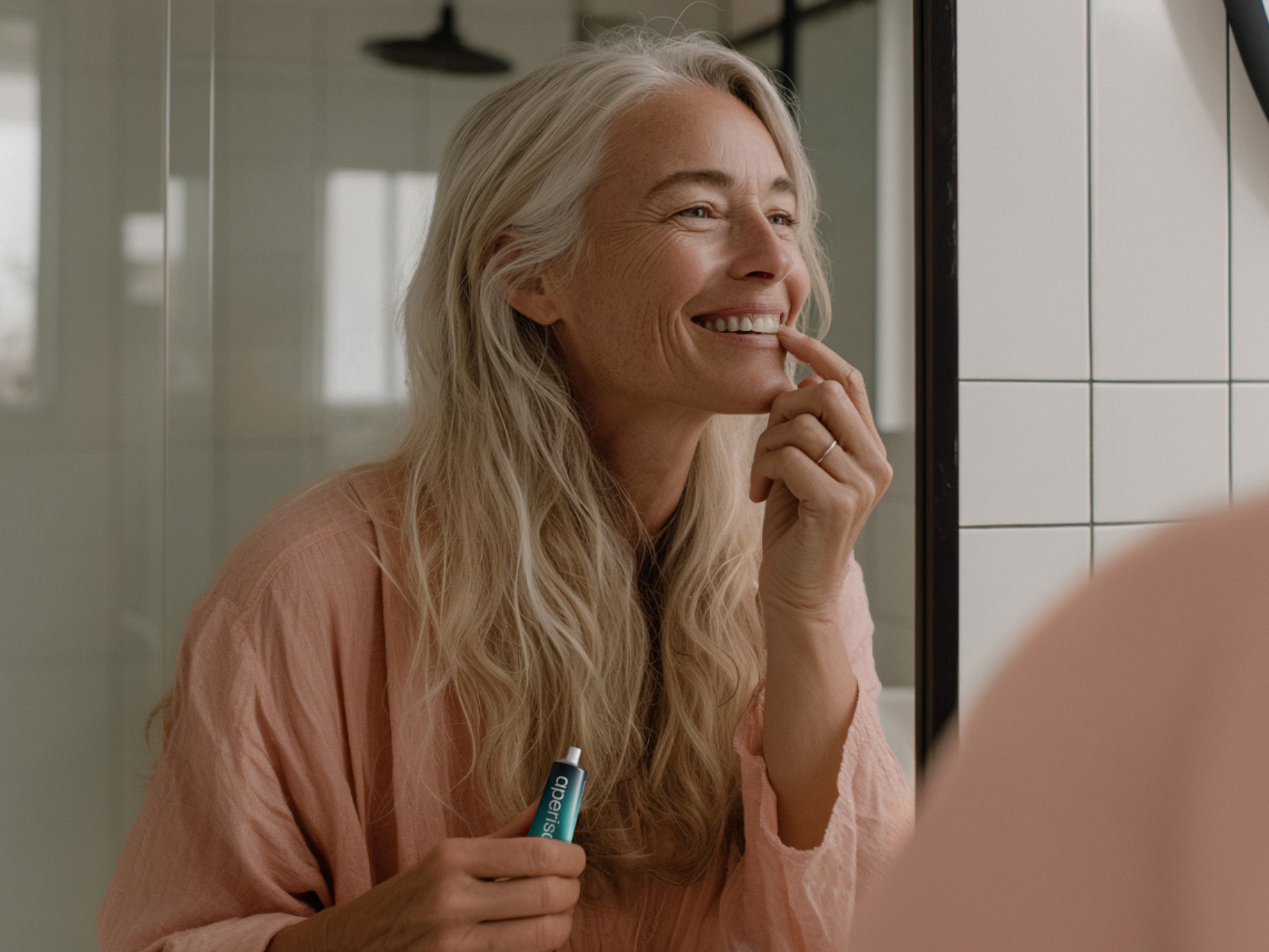 Frau trägt Aperisan Mundgel Mundflora+ auf